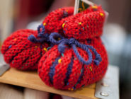 Old Bus Depot Markets Theme Event A Celebration of Wool. Handknitted red and blue baby booties.