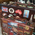 Old Bus Depot Markets - Collectable Sunday Stallholder, Remys. Vintage suitcase covered with stickers