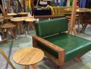 Green leather and timber chair with round timber side table at Old Bus Depot Markets theme event, Retro Depot