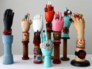 Brightly coloured rings and bracelets display on manequin hands by Old Bus Depot Markets stallholder, She Visits