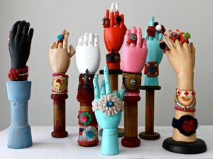 Brightly coloured rings and bracelets display on manequin hands by Old Bus Depot Markets stallholder, She Visits