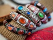 4 rings with brightly coloured glass stones and enamel at the Old Bus Depot Markets for International Day