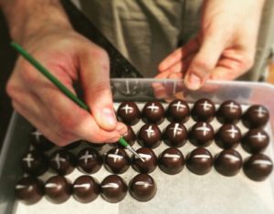 Old Bus Depot Markets Stallholder, Stuart Strutt-Shotton from Enigma Fine Chocolates Decorating Hot Cross Bun Truffles