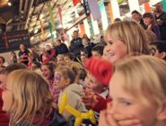 Kids enjoy a performance by Milo the Clown at annual theme event, Kids in the Shed at the Old Bus Depot Markets