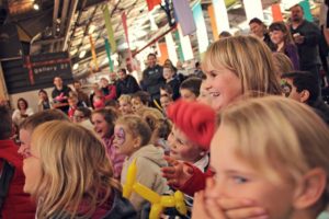 Kids enjoy a performance by Milo the Clown at annual theme event, Kids in the Shed at the Old Bus Depot Markets