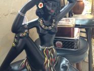 Black ceramic figurine with grass skirt and floral necklace at the Old Bus Depot Markets