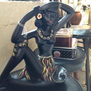 Black ceramic figurine with grass skirt and floral necklace at the Old Bus Depot Markets