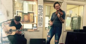 Musical duo, Guyy and the Fox, busking on the lower level of the at the Old Bus Depot Markets
